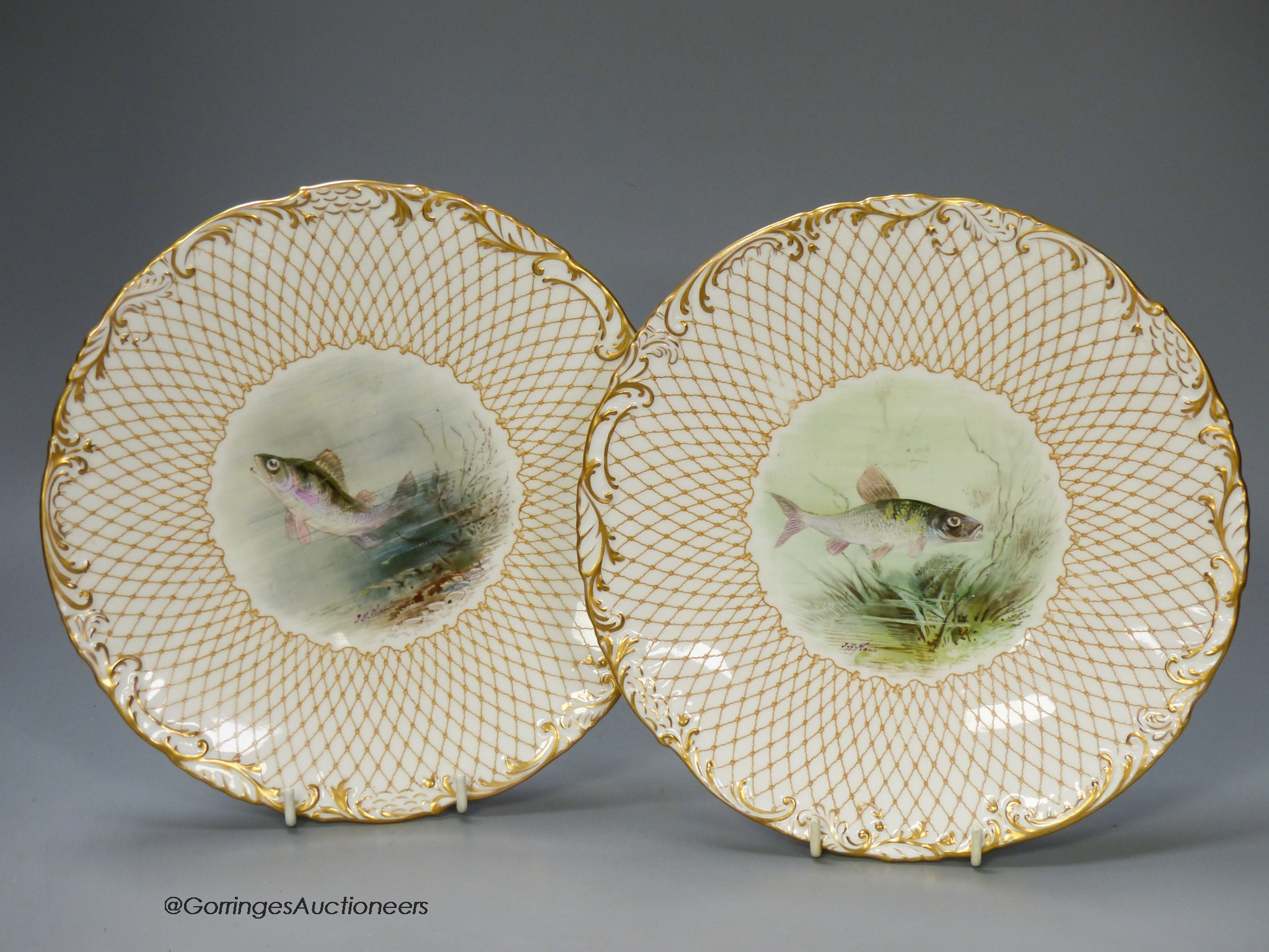 A Wedgwood pair of plates painted with named fish by J.H.Plant, signed